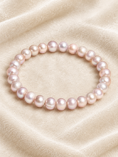 Pink freshwater pearl stretch bracelet on cream velvet