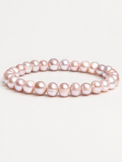 Pink freshwater pearl stretch bracelet on a neutral background