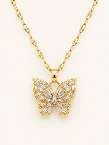 Gold necklace with an openwork butterfly set with clear crystals on a neutral background