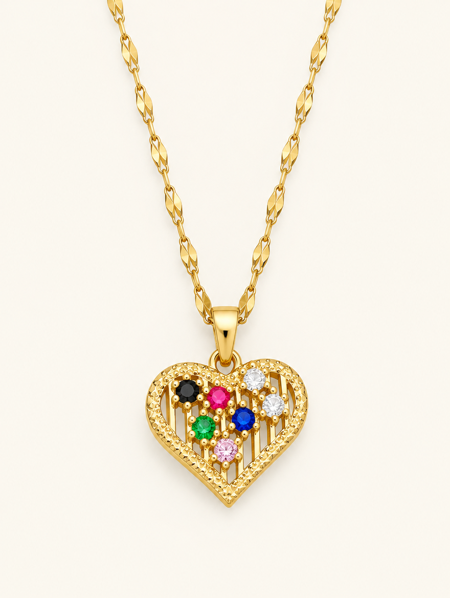 Gold necklace with an openwork heart set with colourful crystals on a neutral background