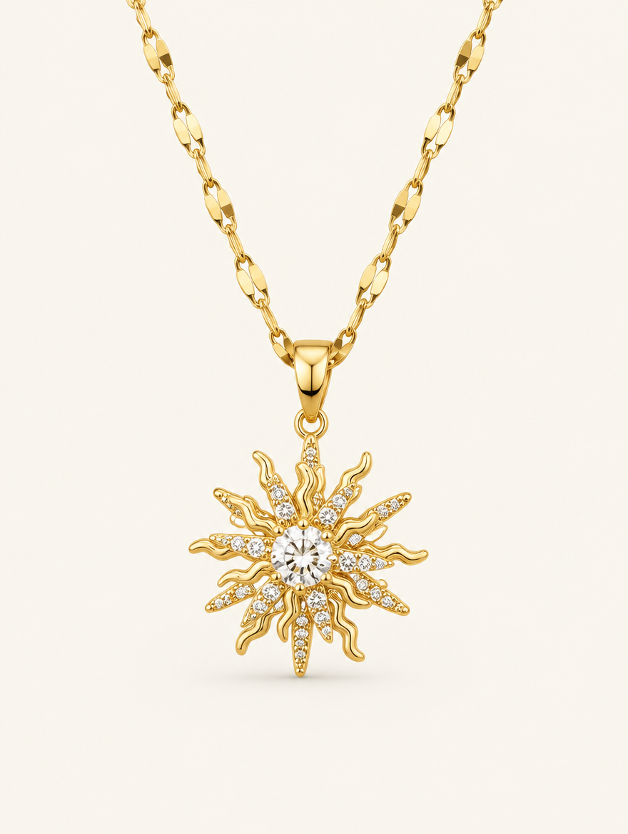 Gold necklace with a sun with a central clear zirconia stone and pointed rays on a neutral background