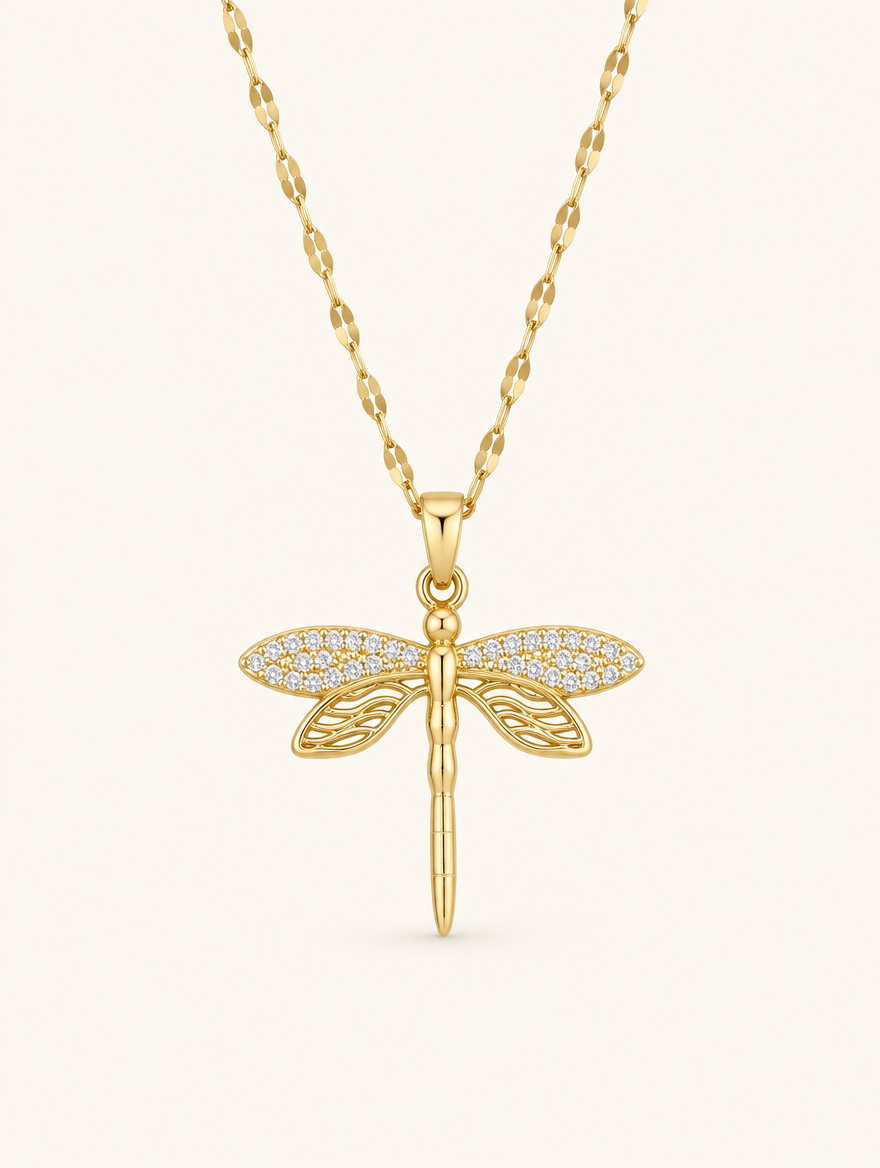 Gold necklace with a dragonfly with sparkling crystal wings on a neutral background