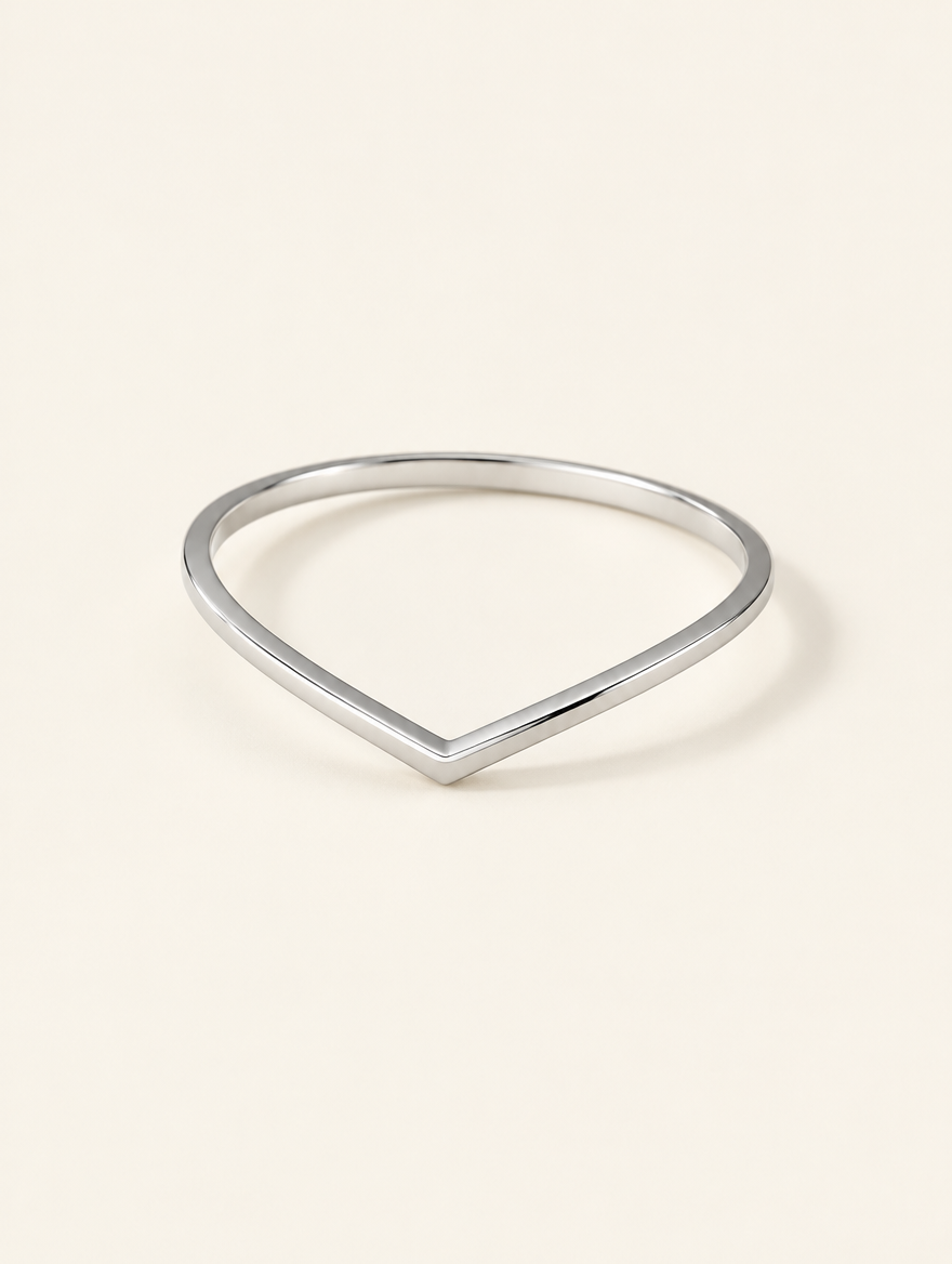 Silver slim chevron band ring on a neutral background