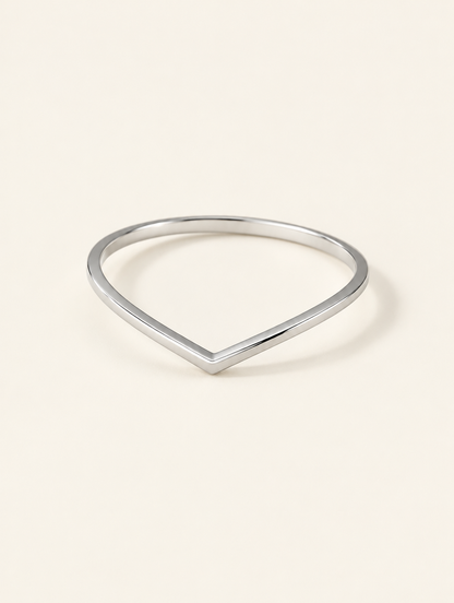 Silver slim chevron band ring on a neutral background