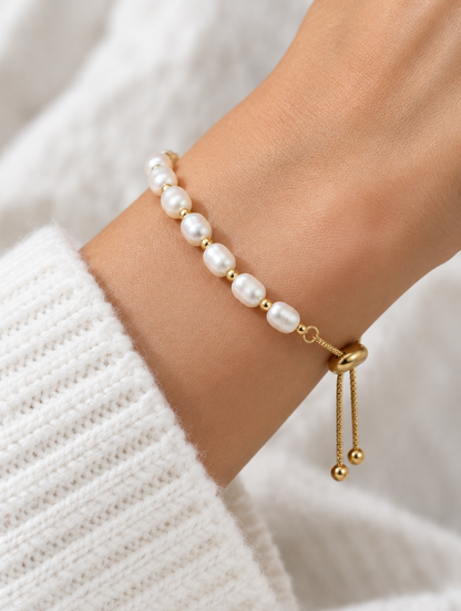 Woman wearing a gold-tone freshwater pearl slider bracelet