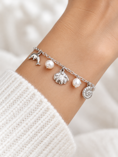 Woman wearing a silver-tone ocean charm bracelet
