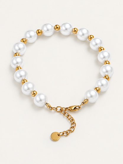 Faux pearl bracelet with gold-tone beads on a neutral background