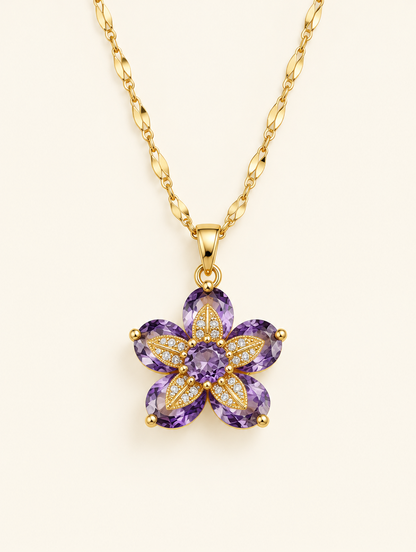 Gold necklace with a flower with purple crystal petals on a neutral background