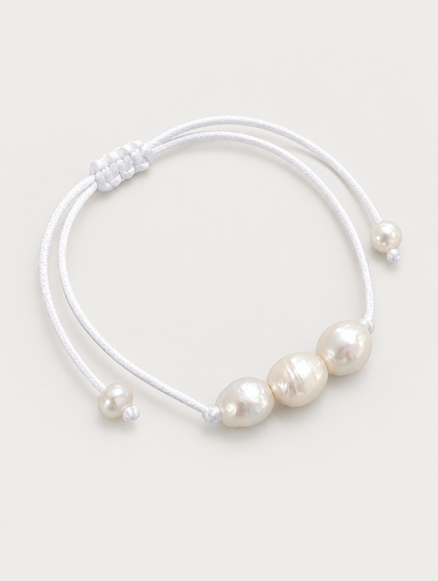 White cord bracelet with baroque freshwater pearls on a neutral background