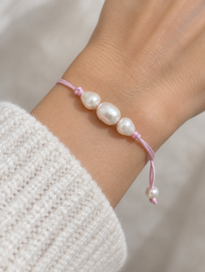 Light Pink cord bracelet with baroque freshwater pearls worn on a wrist