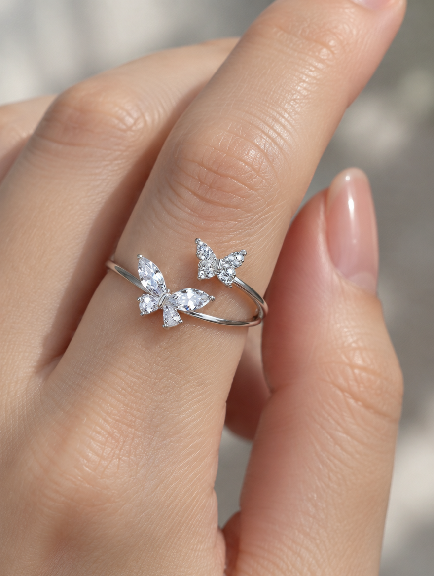 Woman wearing a silver twin butterfly sparkling open ring on her finger