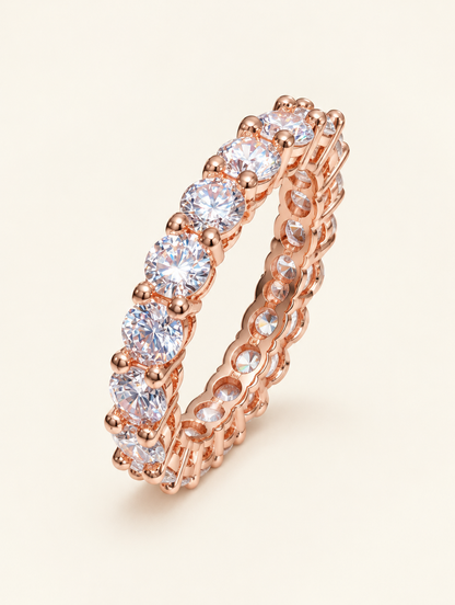 Rose gold zirconia eternity band ring on a neutral background